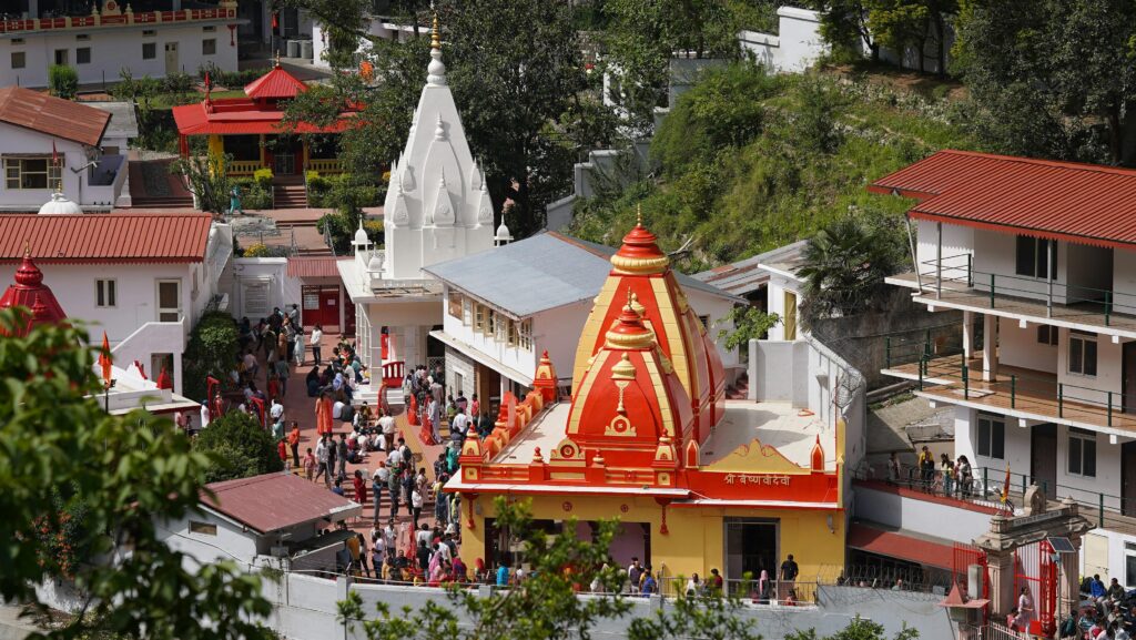 A lively aerial view of Kainchi Dham temple complex capturing its vibrant architecture and bustling activity.